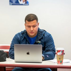 Student typing on their laptop