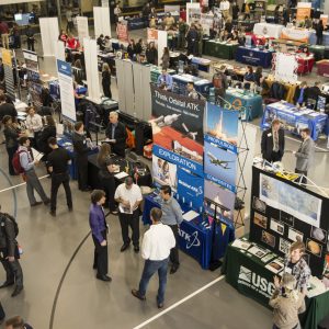 Aereal of tables of employers with students walking along in front