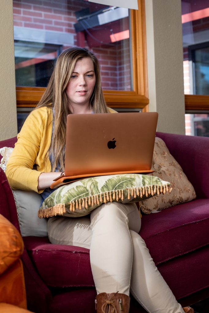 Female NAU Online student on laptop
